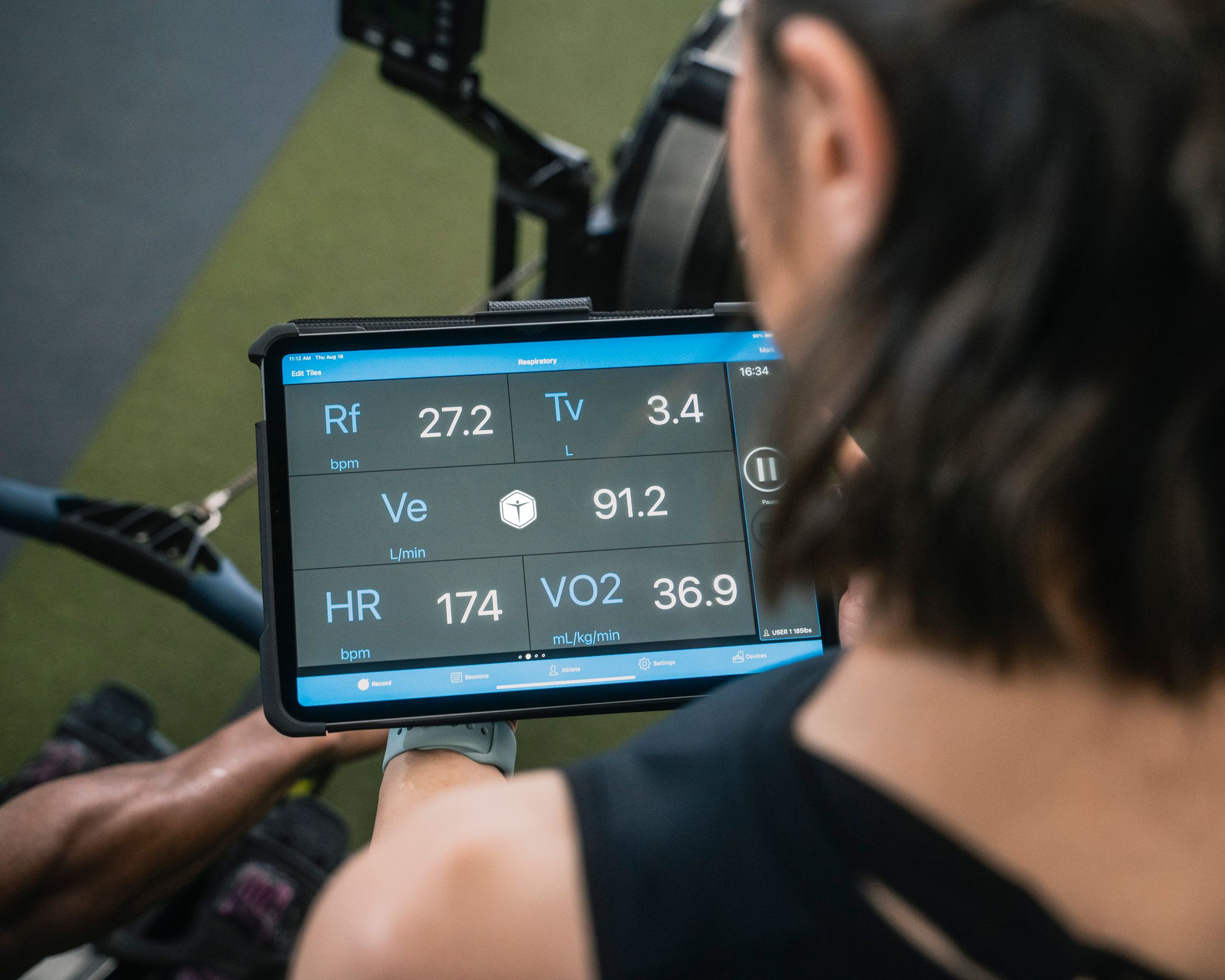 Performance metrics displayed on a tablet during a coached fitness session.