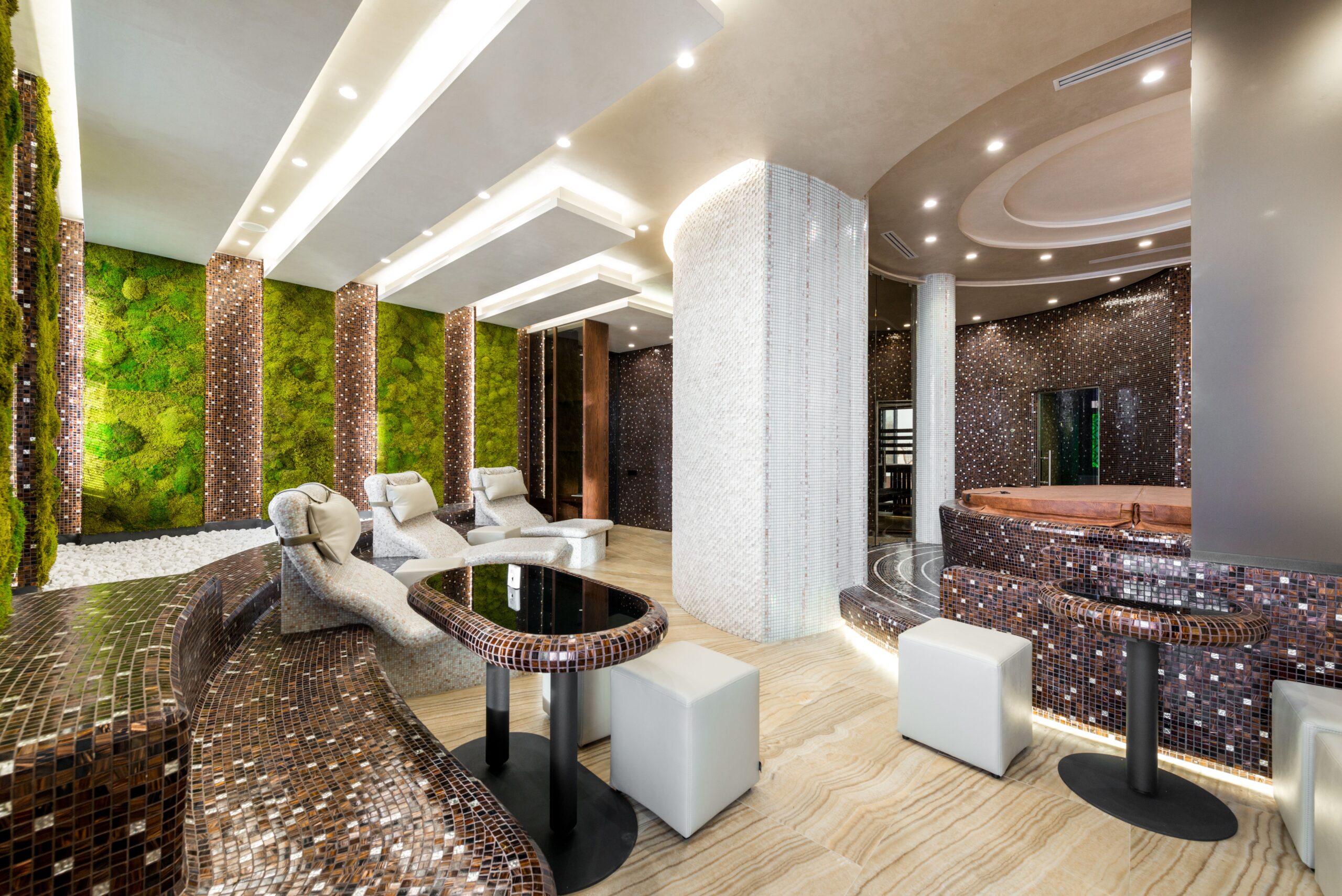 A professionally designed wellness and recovery lounge with treatment areas and room for member flow.